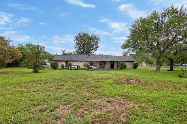 Rear view of house with a yard | Image 24