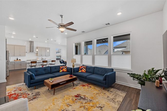 Living area with recessed lighting, baseboards, dark wood finished floors, ceiling fan, and visible vents | Image 9