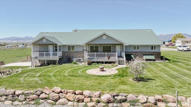 View of front facade with a mountain view, a front lawn, and a metal roof | Image 9