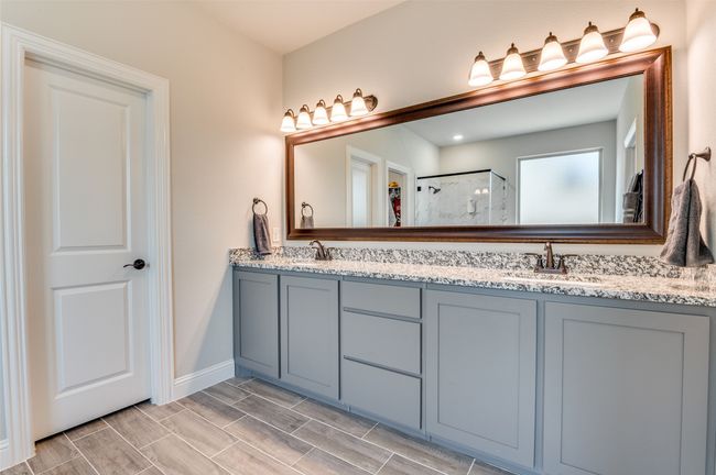 Full bath with double vanity, wood tiled floors, and a shower | Image 27