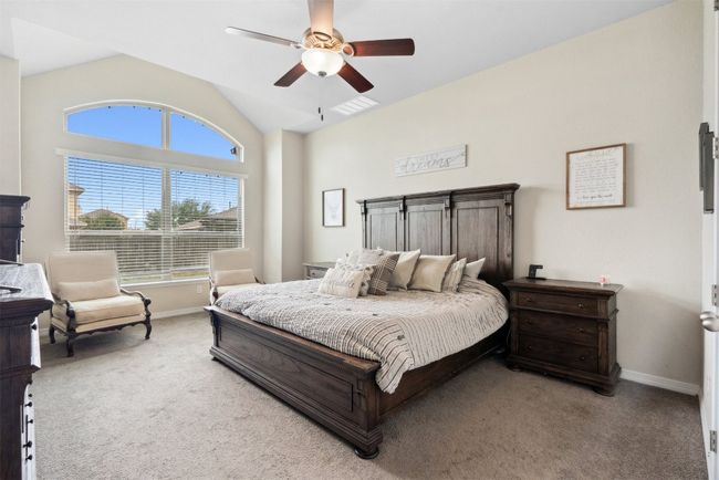 The spacious primary bedroom offers a peaceful escape, with plenty of room for your king-sized furniture and a cozy sitting area | Image 15