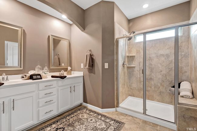 The master bath has a separate water closet for privacy. The shower has ample room plus a seat. Double vanities & decorative mirrors. | Image 27