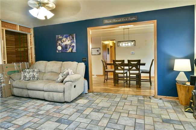 Living area with a ceiling fan and baseboards | Image 16