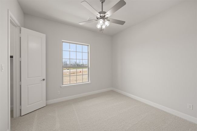 Carpeted empty room with baseboards and ceiling fan | Image 24