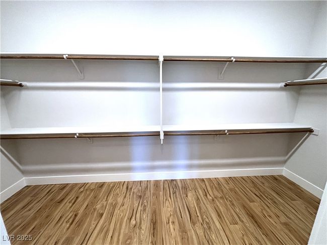 Spacious closet with wood finished floors | Image 24