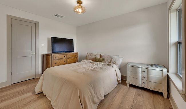 Bedroom with light wood-type flooring | Image 32