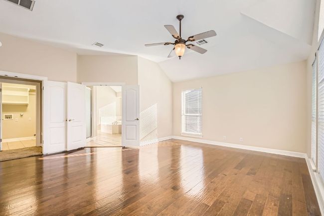 Unfurnished bedroom with visible vents and hardwood / wood-style floors | Image 24