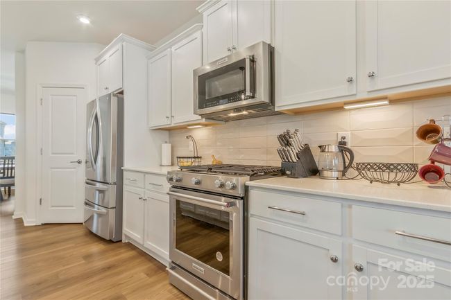 Under lighting on the cabinets. Soft close draws & cabinets. Convection microwave. You can airfry using your microwave. Gas stove. Fridge comes with the home. Walk-in pantry. | Image 7