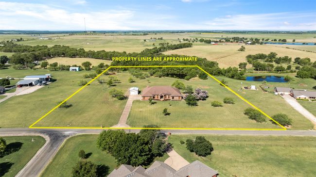 Aerial view of sparsely populated area with property boundaries highlighted and a large body of water | Image 30