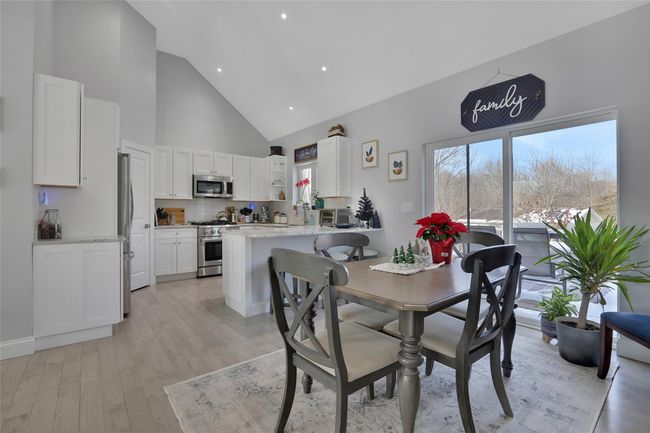 Dining area featuring high vaulted ceiling and light hardwood / wood-style floors | Image 10