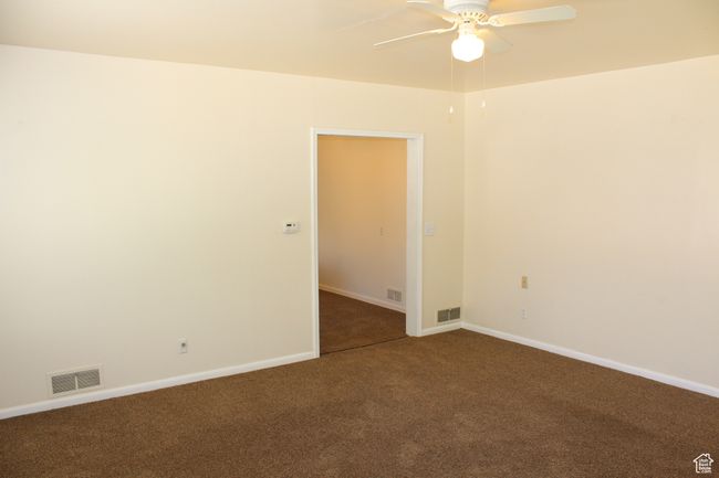 Carpeted empty room with ceiling fan and baseboards | Image 26