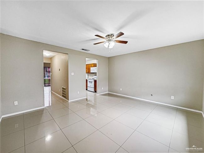 Tiled empty room featuring ceiling fan | Image 7