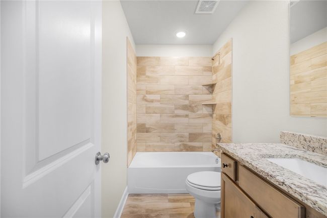 Bathroom with vanity, toilet, shower / washtub combination, and recessed lighting | Image 19