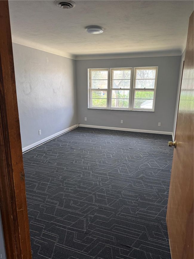 Spare room with baseboards and visible vents | Image 4
