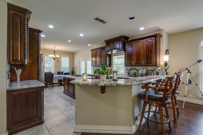 Kitchen with a chandelier, a kitchen breakfast bar, recessed lighting, a peninsula, and healthy amount of natural light | Image 11