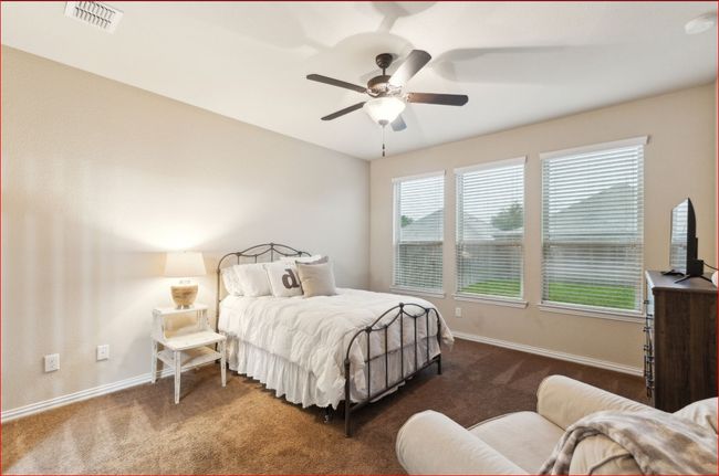 Bedroom with dark colored carpet and a ceiling fan | Image 15