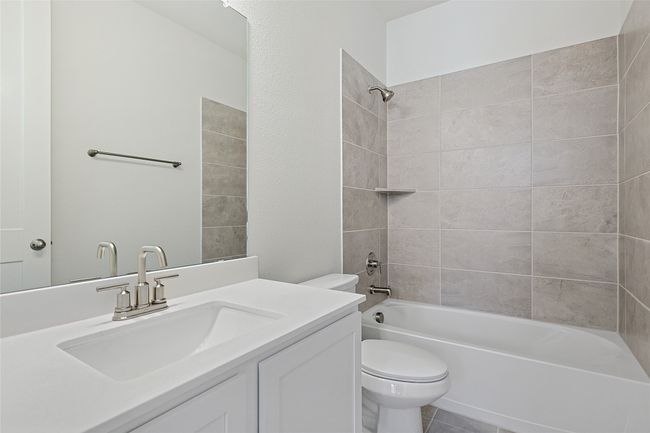 Full bathroom featuring tiled shower / bath combo, vanity, and toilet | Image 39