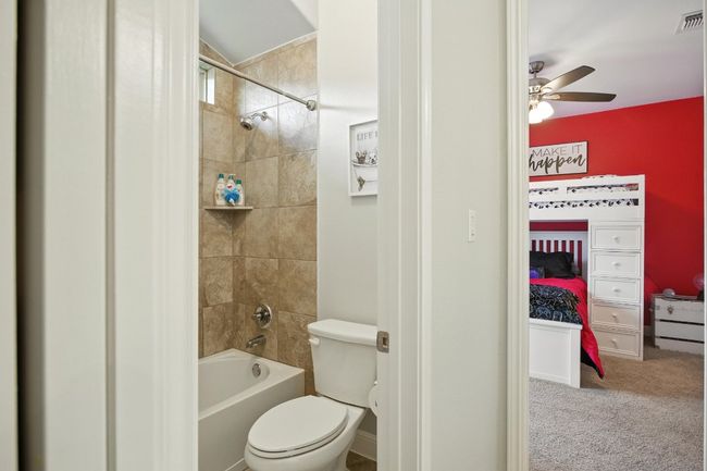 Full bathroom with shower / washtub combination, a ceiling fan, and ensuite bathroom | Image 26