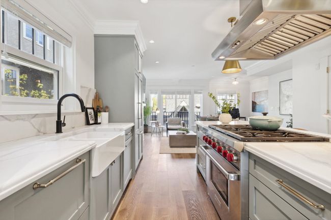 Kitchen featuring recessed lighting, range hood, wood finished floors, gray cabinetry, and high end range | Image 5