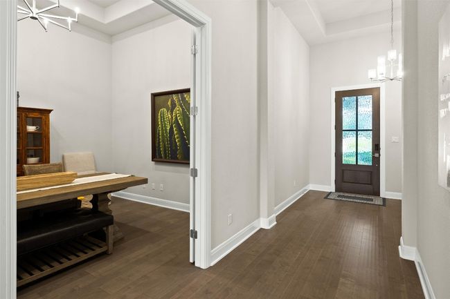 Entrance foyer featuring a chandelier and dark wood-style flooring | Image 8