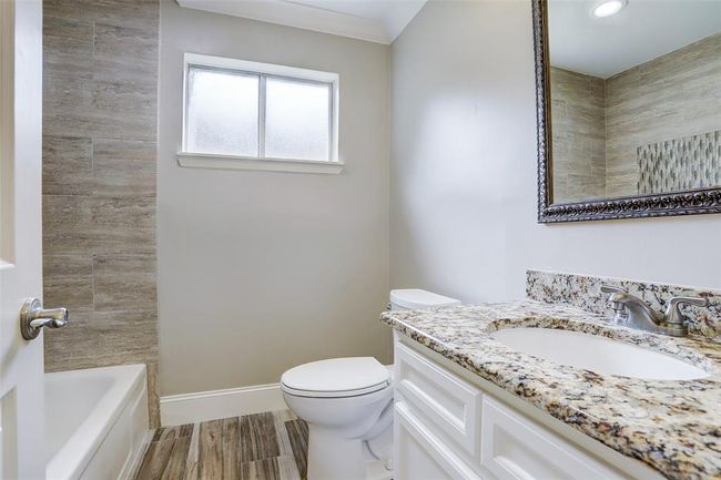 Guest bathroom in the hallway near the secondary bedrooms. | Image 25