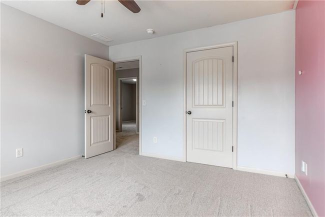 Unfurnished bedroom featuring carpet floors and ceiling fan | Image 39