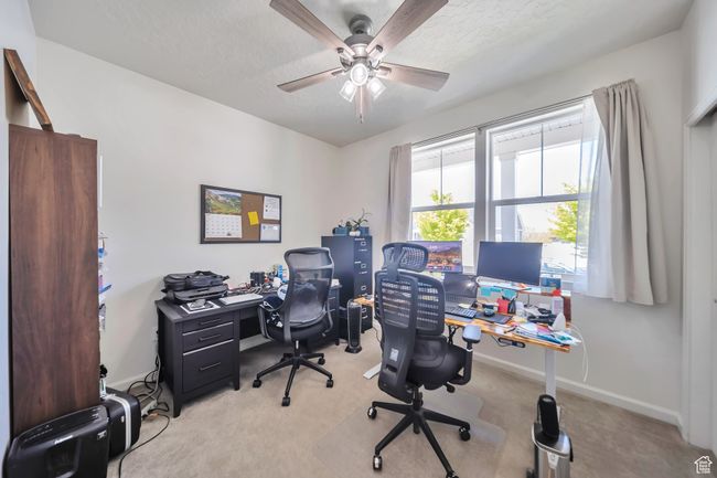 Home office with a ceiling fan, baseboards, a textured ceiling, and light colored carpet | Image 16