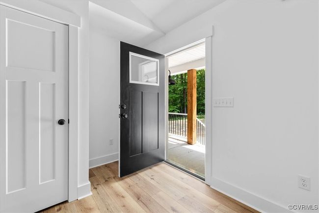 Entryway featuring light wood-style flooring, baseboards, and lofted ceiling | Image 4