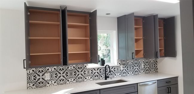 Kitchen with open shelves, dishwasher, gray cabinets, a sink, and tasteful backsplash | Image 14