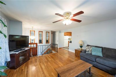 Living room with ceiling fan and light hardwood flooring | Image 3