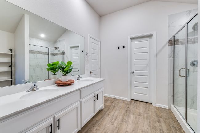 Bathroom with a stall shower, wood finished floors, and a sink | Image 17