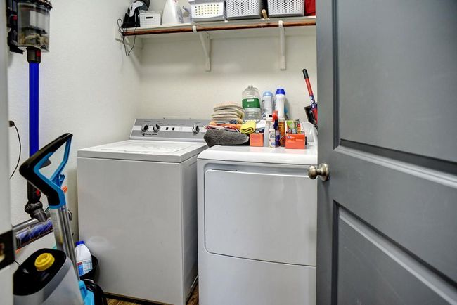Laundry area with washing machine and clothes dryer and laundry area | Image 32