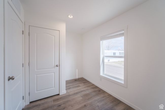 Empty room with recessed lighting, wood finished floors, and baseboards | Image 19