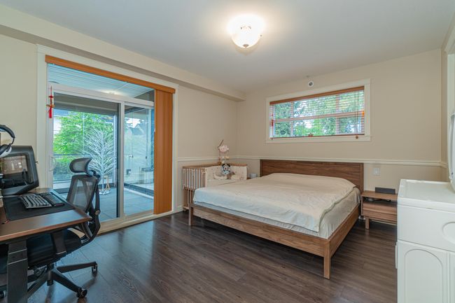 Bedroom with multiple windows, wood finished floors, and access to exterior | Image 17