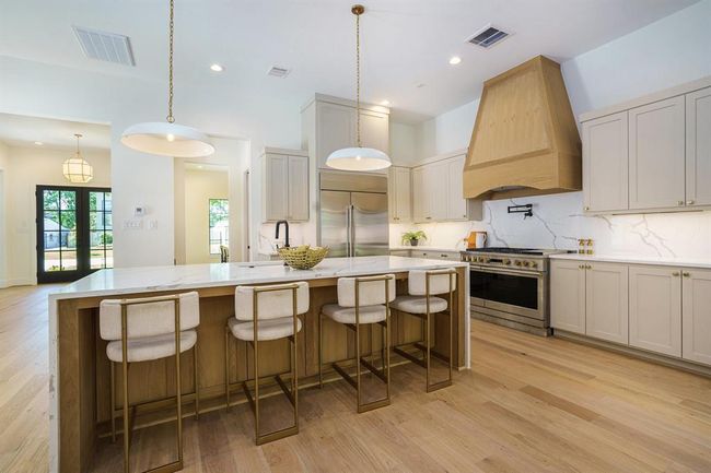 The white oak vent hood is the centerpiece. | Image 9