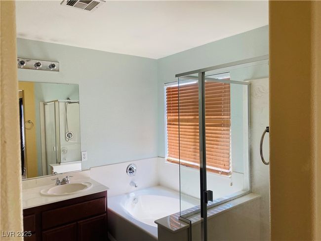 Full bath with vanity, a shower stall, a garden tub, and visible vents | Image 13