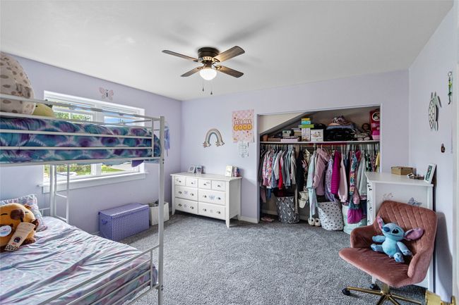 Bedroom with a closet, carpet floors, and a ceiling fan | Image 61