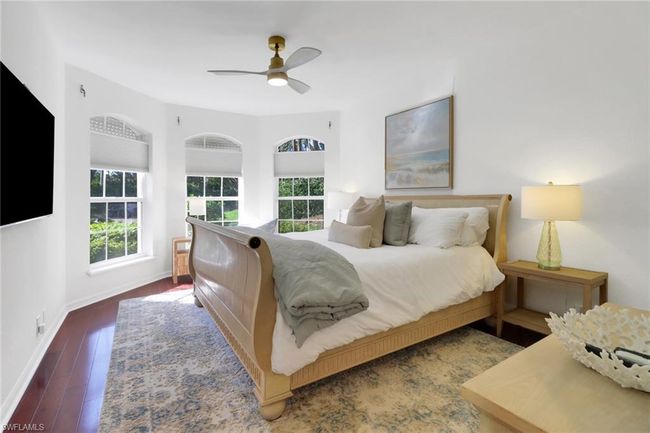 Bedroom featuring baseboards, a ceiling fan, and wood finished floors | Image 17