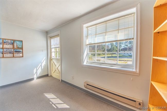 Spare room featuring a baseboard radiator and ornamental molding | Image 11