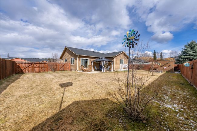 Rear view of house with a gazebo, a lawn, a patio, and a fenced backyard | Image 20