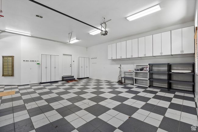 Garage featuring a garage door opener | Image 66
