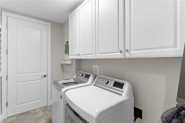 Laundry room featuring separate washer and dryer and cabinet space | Image 25