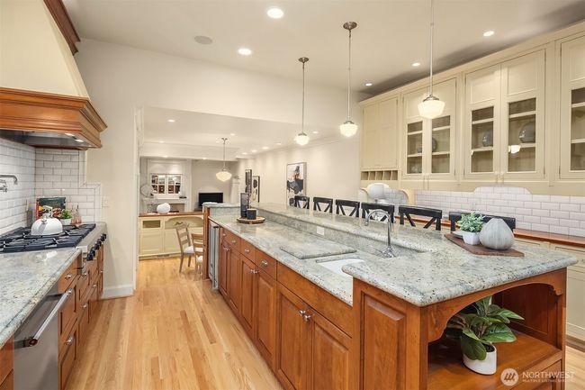 All custom cabinetry... note the stunning painted cabinets with cherry tops and glass doors on the right hand side of this picture. | Image 9