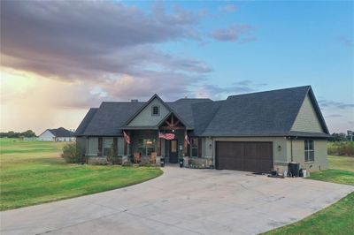 View of front of home featuring a garage and a lawn | Image 1