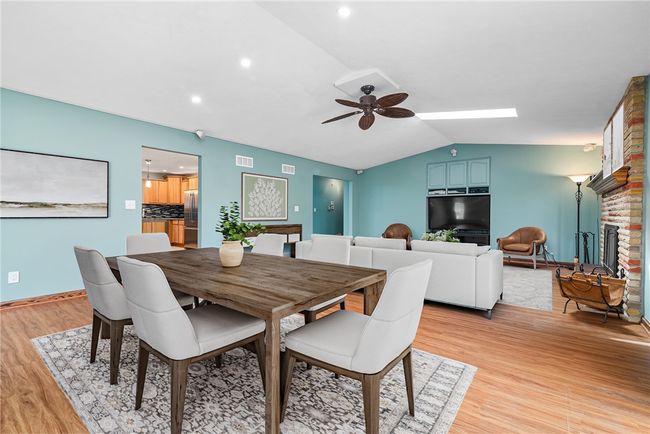 Fall in love with the great room offering a gas fireplace, cathedral ceiling, skylights, access to the private deck and an abundance of windows | Image 13