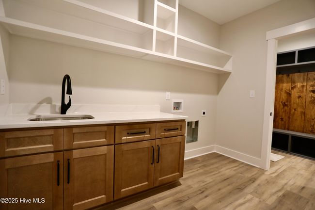 Oversized laundry w/sink & cabinetry + overhead wood shelving | Image 26