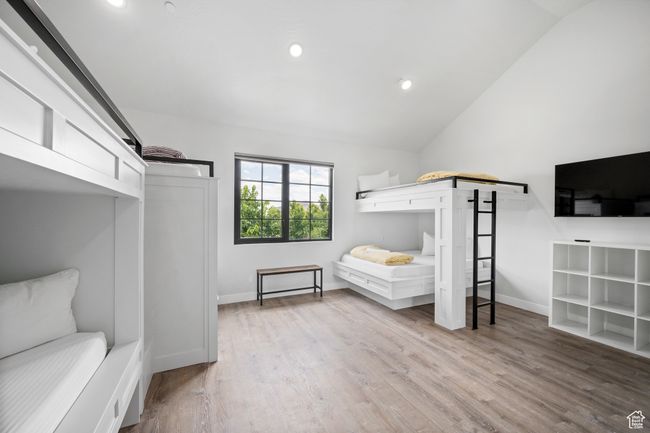 Bedroom featuring lofted ceiling and light wood-type flooring | Image 22