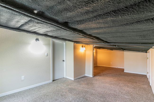 Finished below grade area featuring carpet and baseboards | Image 23