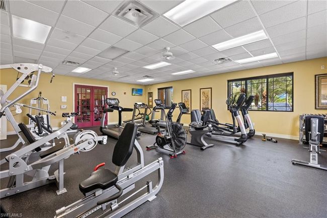 Exercise room featuring a paneled ceiling | Image 26