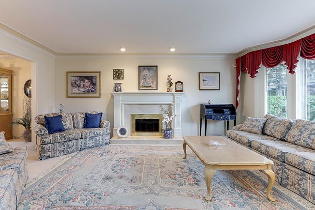 Living room featuring crown molding and a high end fireplace | Image 4